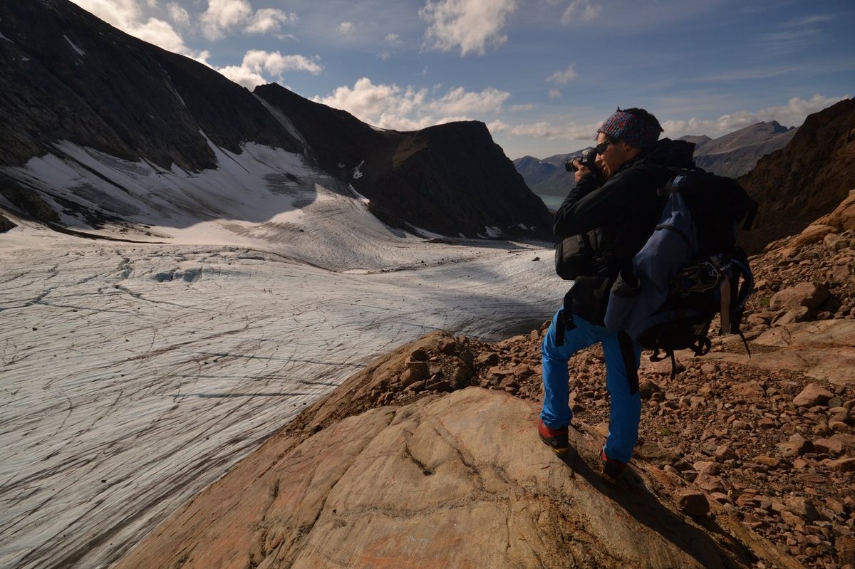 Photographer on a ridge above the glacier tongue, one of four peaks climbed to acquire SfM imagery