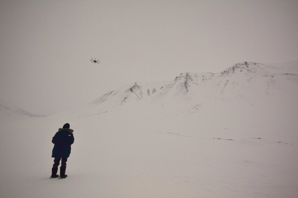 Flying the hexacopter over a Svalbard survey site under flat overcast. Low-contrast, featureless snow under diffuse light is precisely the scenario where SfM feature matching fails.